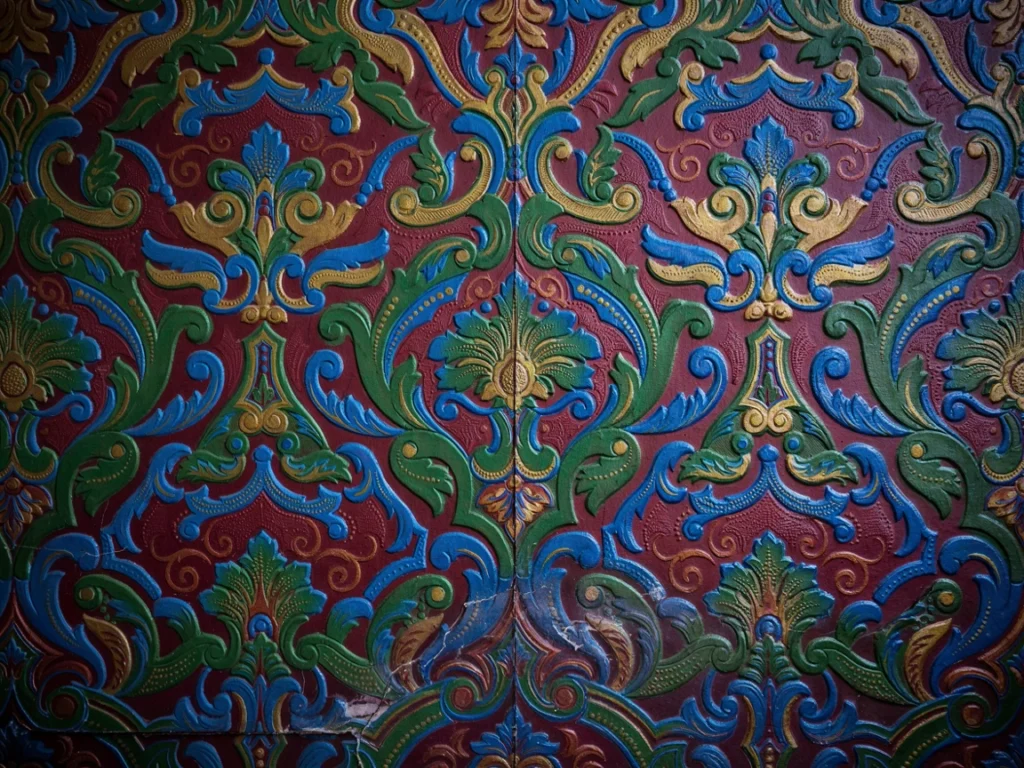 Close-up of textured 90s wallpaper pattern in deep colors