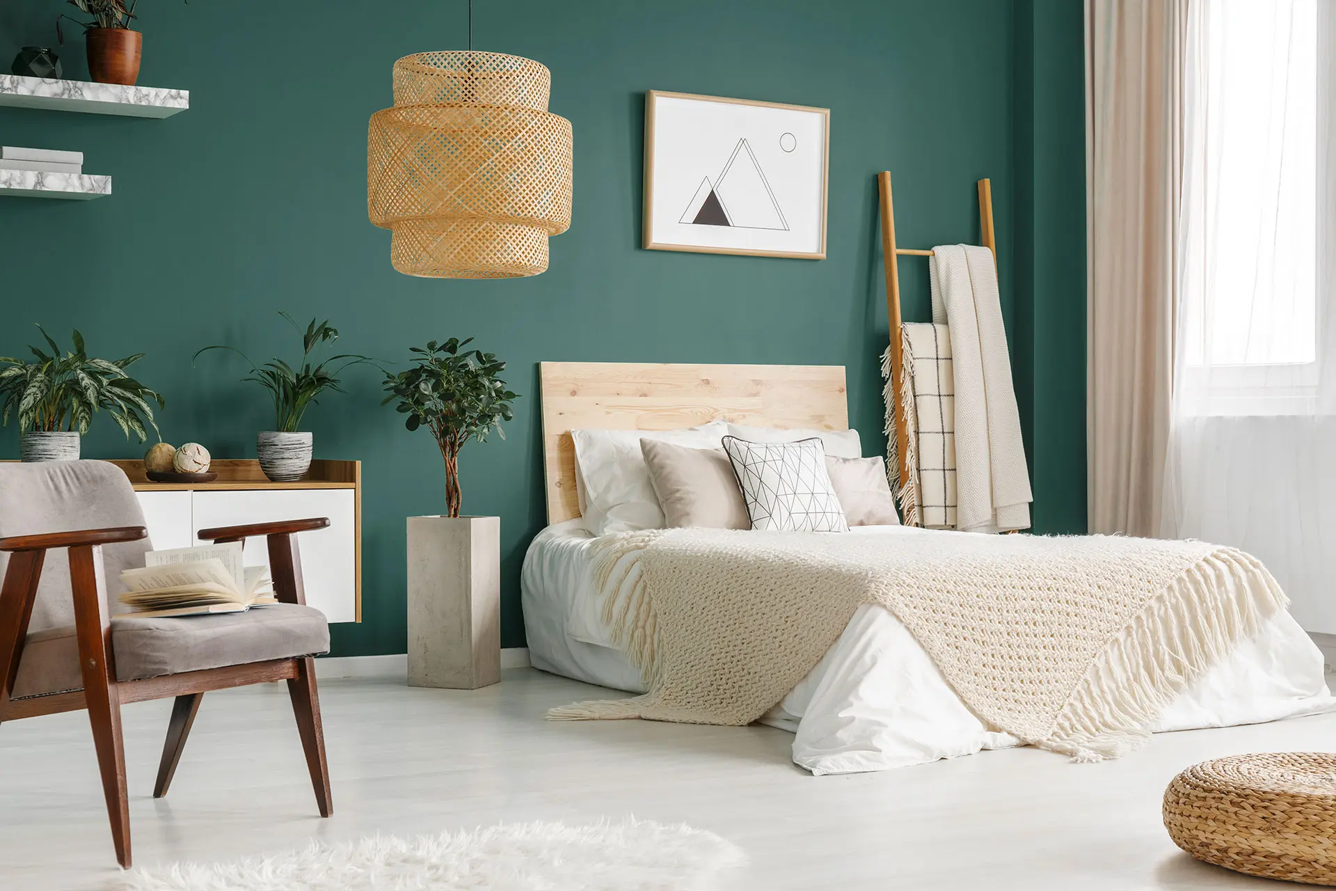 Cozy green bedroom with wooden bed frame, woven pendant light, and boho decor